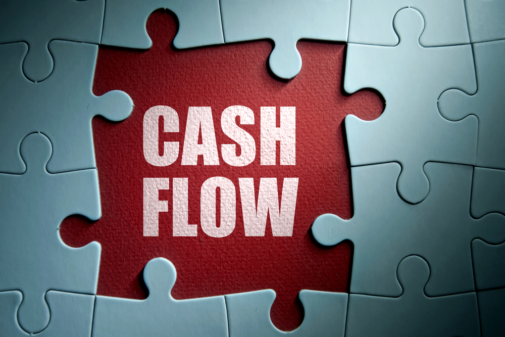 Missing pieces from a jigsaw puzzle revealing cash flow